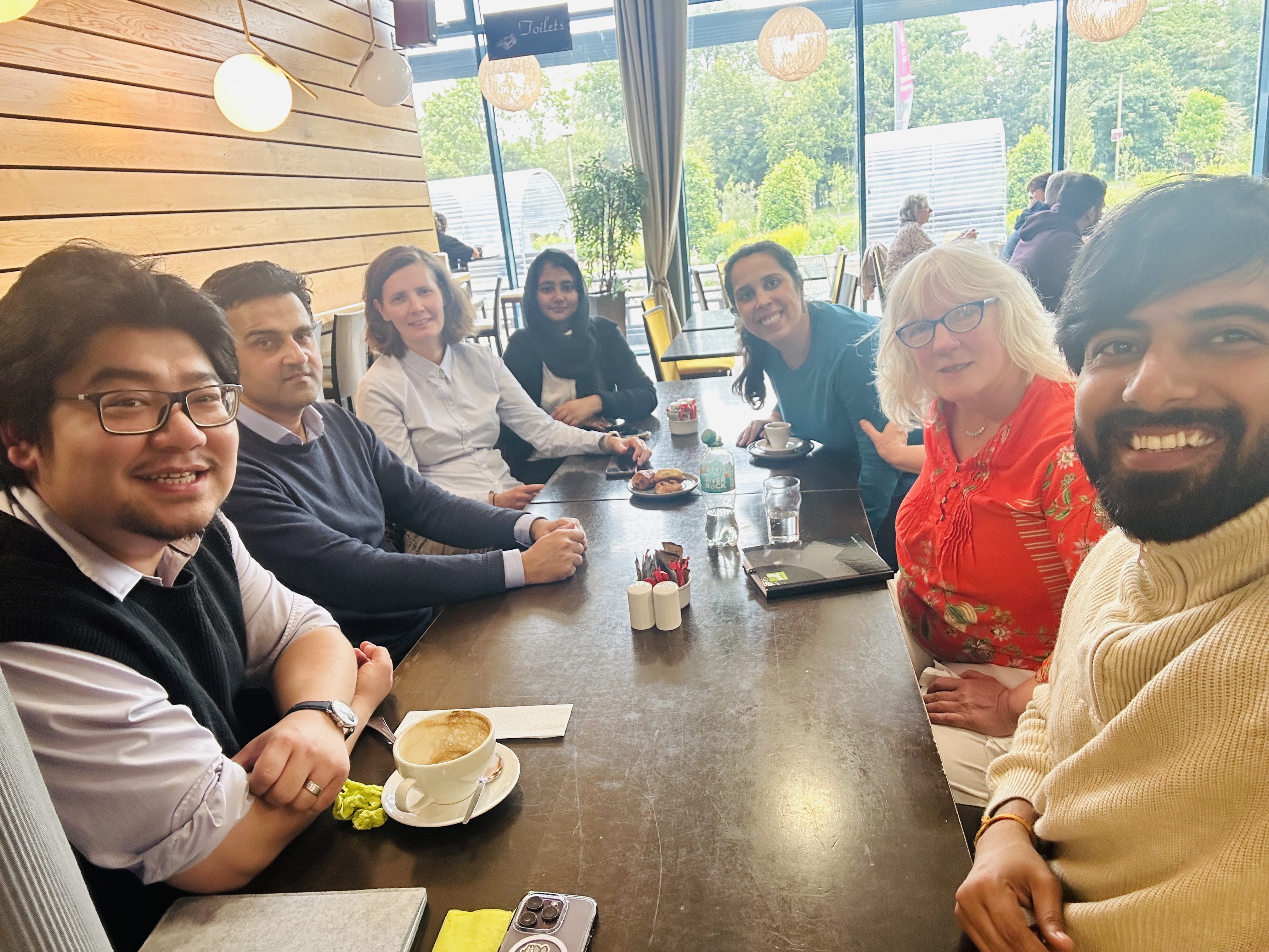 A group of post-doctoral researchers around a table. 