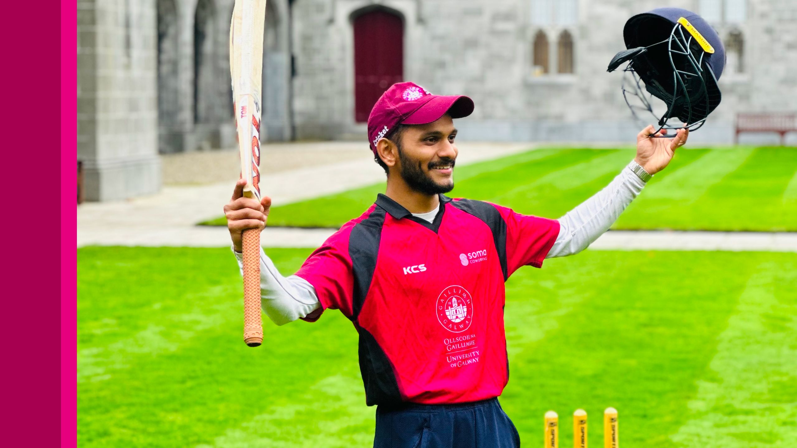 University of Galway cricket team members raises his bat and helmet in the air in the Quadrangle
