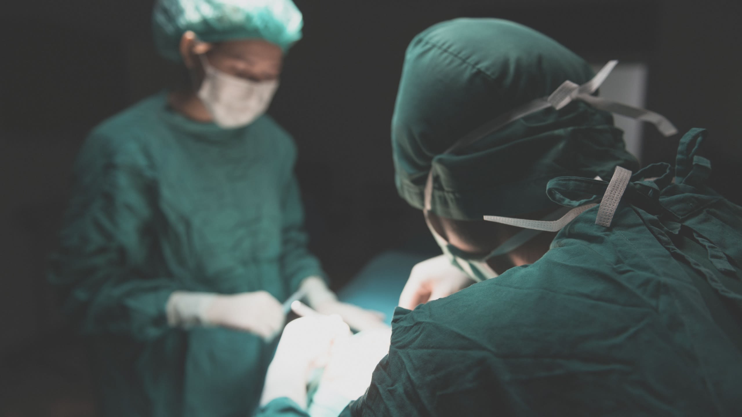 Surgery team operating in a surgical room
